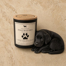 Black cylindrical handmade candle with wooden lid and dog-themed label by black dog candle shoppe for dog people