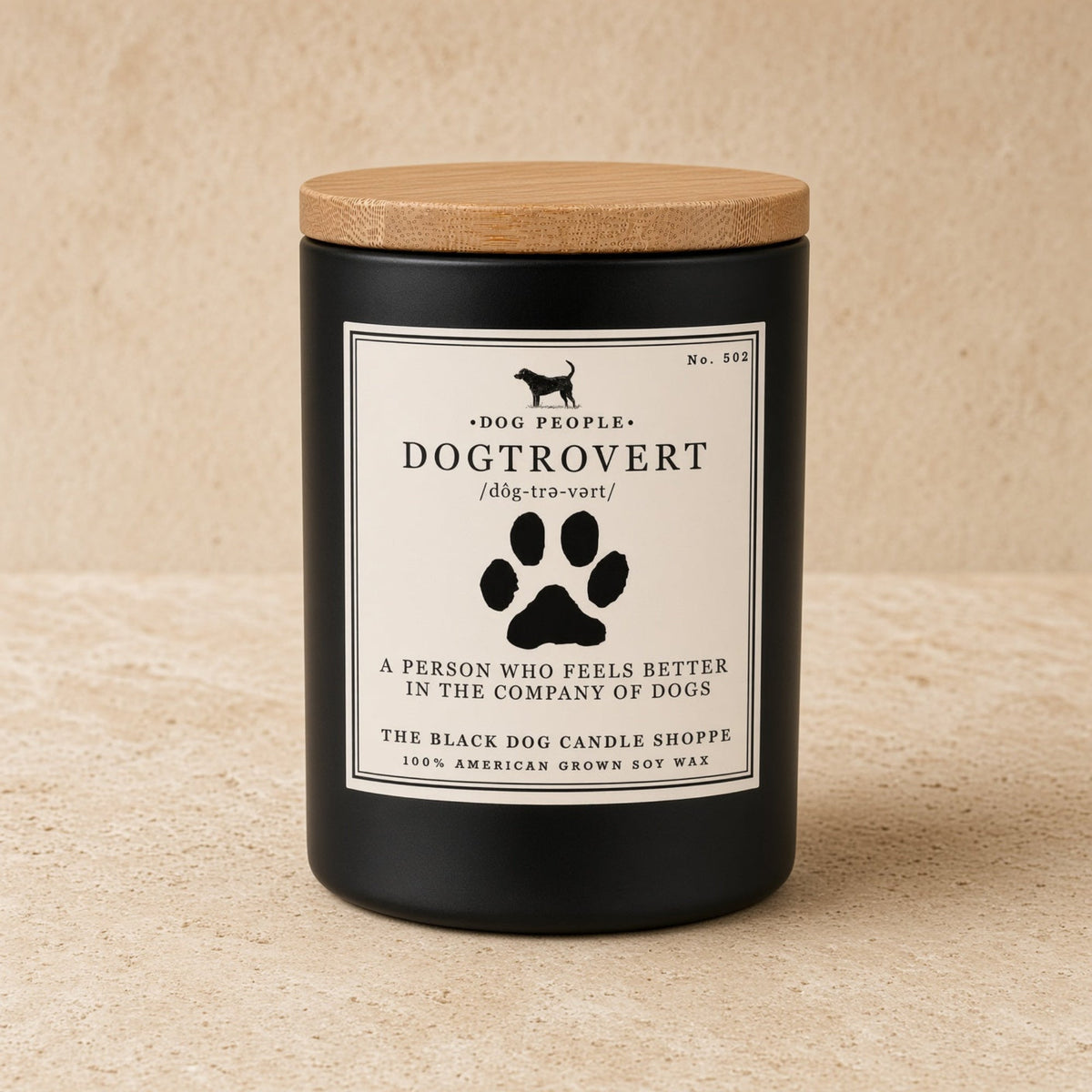 Black cylindrical soy wax candle with natural wood lid and dog silhouette label by black dog candle shoppe for dog people