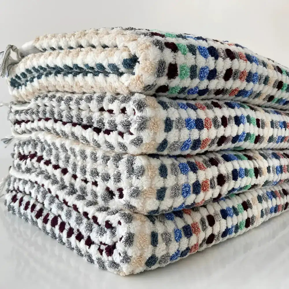 Handwoven Turkish terrycloth towel with dots in multiple colors and fringe.