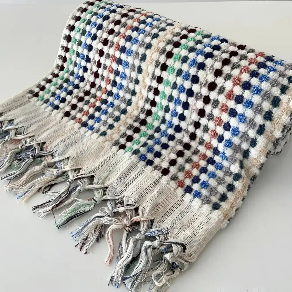 Handwoven Turkish terrycloth towel with dots in multiple colors and fringe.