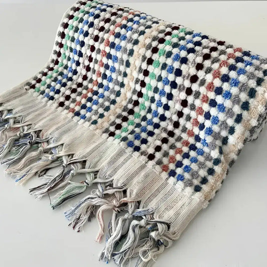 Handwoven Turkish terrycloth towel with dots in multiple colors and fringe.