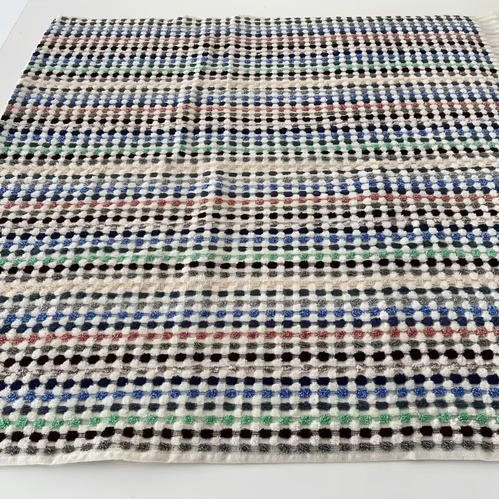 Handwoven Turkish terrycloth towel with dots in multiple colors and fringe.