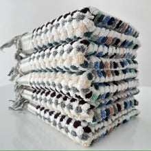 Handcrafted Turkish terrycloth cotton oversized hand towel with pastel colored dots.