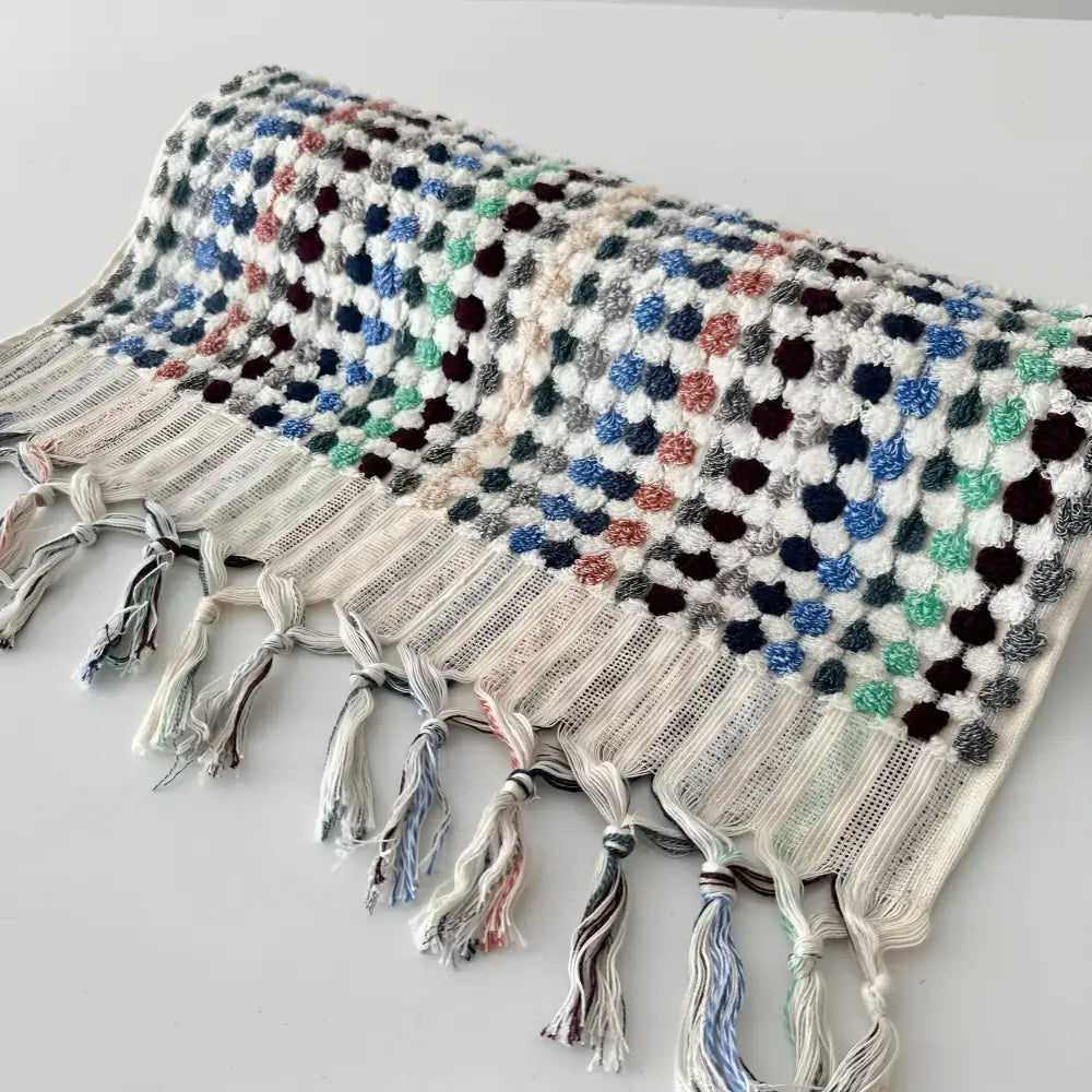 Handcrafted Turkish terrycloth cotton oversized hand towel with pastel colored dots.