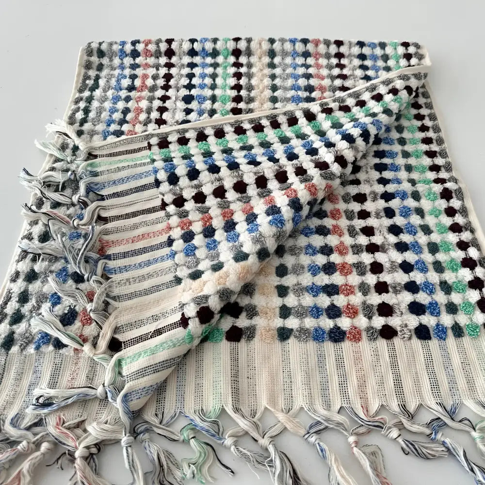 Handcrafted Turkish terrycloth cotton oversized hand towel with pastel colored dots.
