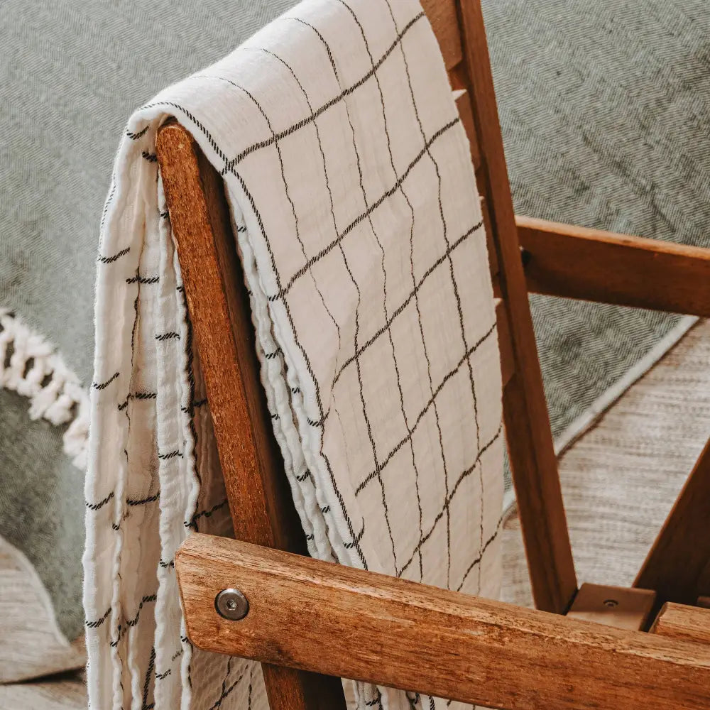 White with charcoal windowpane design 100% cotton muslin oversized throw blanket with fringe.