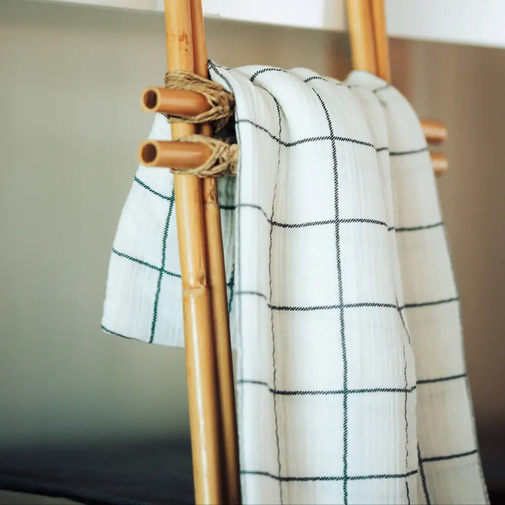White with charcoal windowpane design 100% cotton muslin oversized throw blanket with fringe.