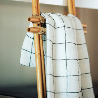 White with charcoal windowpane design 100% cotton muslin oversized throw blanket with fringe.