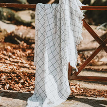 White with charcoal windowpane design 100% cotton muslin oversized throw blanket with fringe.