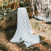 White with charcoal windowpane design 100% cotton muslin oversized throw blanket with fringe.