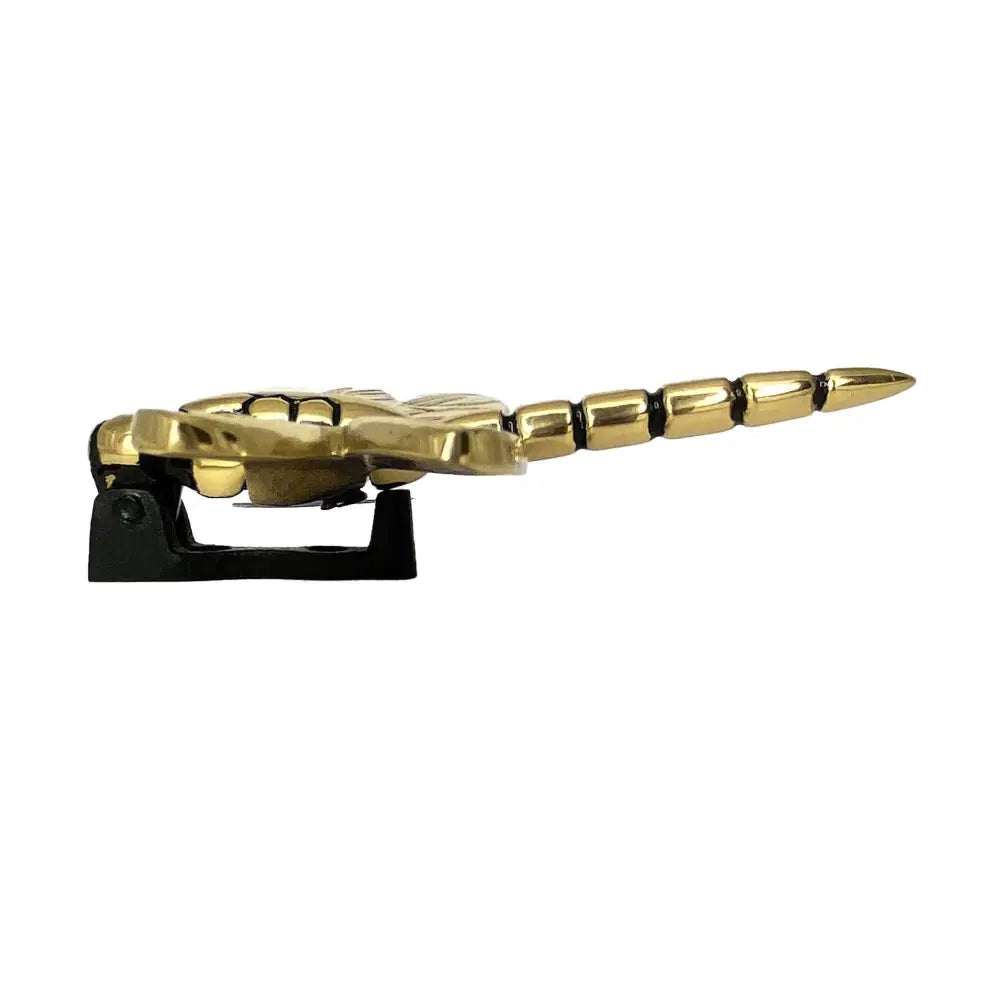 Gold bottle opener shaped like a dragon on a white background