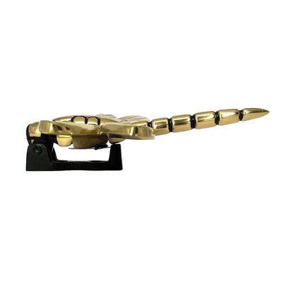 Gold bottle opener shaped like a dragon on a white background