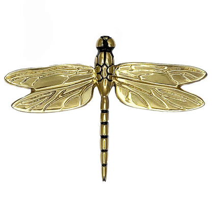 Gold dragonfly-shaped object on a white background