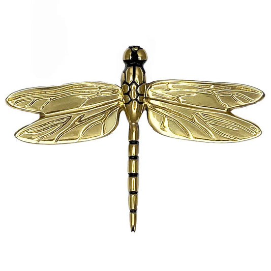 Gold dragonfly-shaped object on a white background