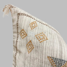 Cotton pillow cover in neutral gray color pallette with hand embroidered details.
