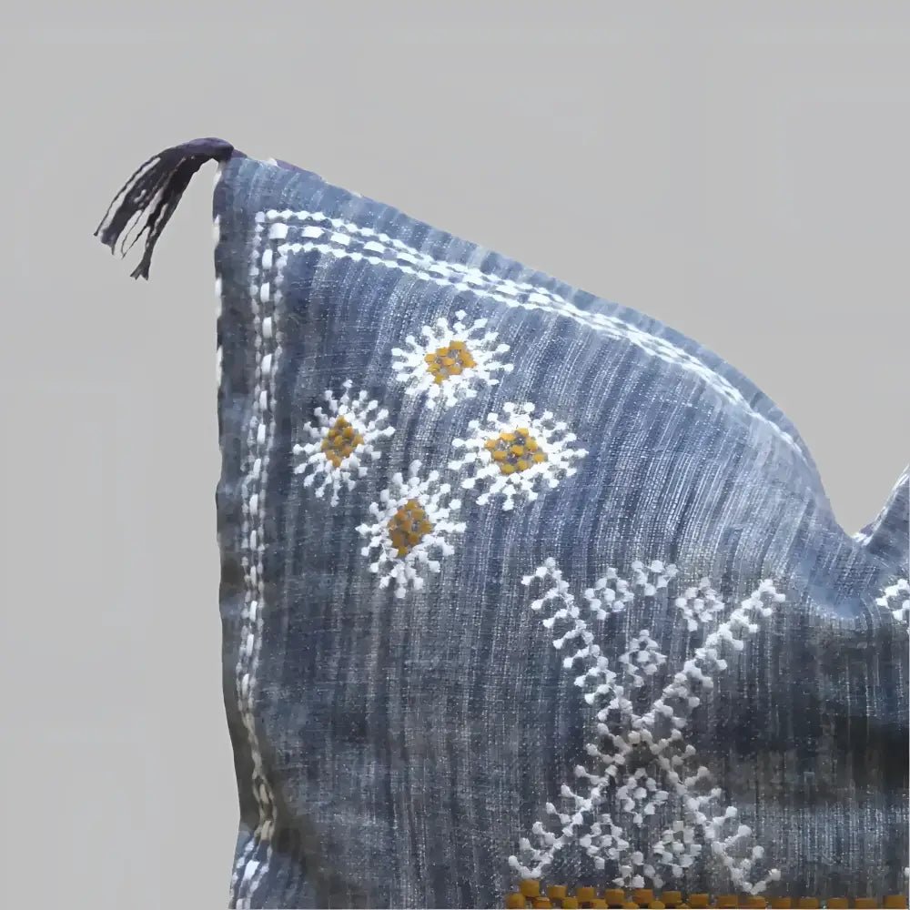 Linen pillow cover 20 inch x 20 inch in blue, with hand embroidered details in white and brown. Tassels on corners and zipper on back side.