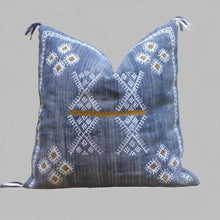 Linen pillow cover 20 inch x 20 inch in blue, with hand embroidered details in white and brown. Tassels on corners and zipper on back side.