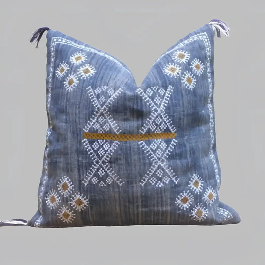 Linen pillow cover 20 inch x 20 inch in blue, with hand embroidered details in white and brown. Tassels on corners and zipper on back side.