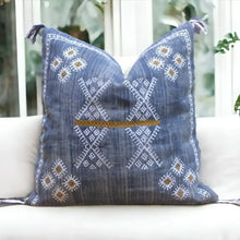 Linen pillow cover 20 inch x 20 inch in blue, with hand embroidered details in white and brown. Tassels on corners and zipper on back side.