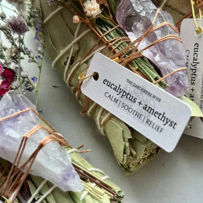 Handmade eucalyptus and amethyst wand with dried leaves, crystals, and twine