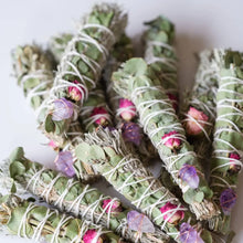 Hand wrapped smudge plants including sage, flowers, eucalyptus, and embellished with crystals.