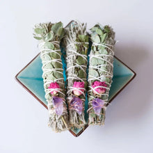 Hand wrapped smudge plants including sage, flowers, eucalyptus, and embellished with crystals.