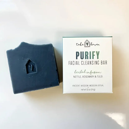Dark blue facial cleansing bar with heart design and house-shaped indentation helps remove excess oil using western herbalism