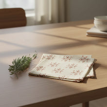 Folded cream-colored organic cotton napkin with hand block printed snowflake pattern