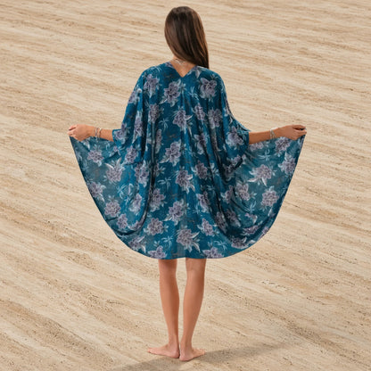 A flowing teal floral kimono cover made of lightweight fabric with a delicate purple floral pattern perfect for the beach