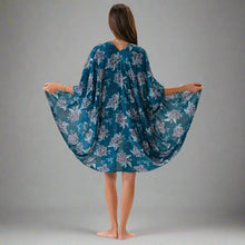 Woman wearing teal floral kimono cover up, perfect for summer beach vibes