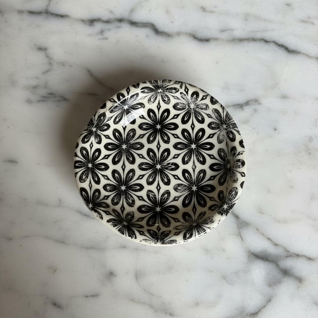 Ceramic spoon rest with black and white floral pattern for kitchen counter use