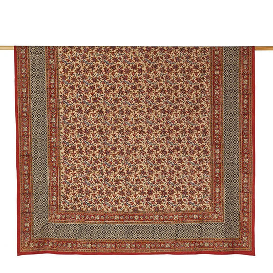 Rust and black multicolor printed tablecloth hanging on a rod.