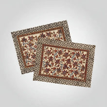 Two floral-patterned cotton vines placemats set with decorative borders for your table