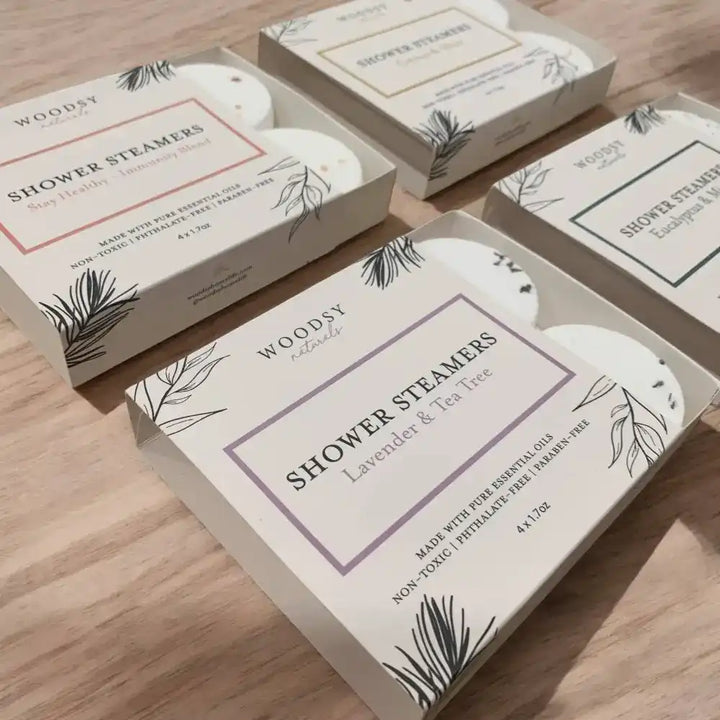 Four open shower steamer gift boxes with bright energizing and sinus clearing blends