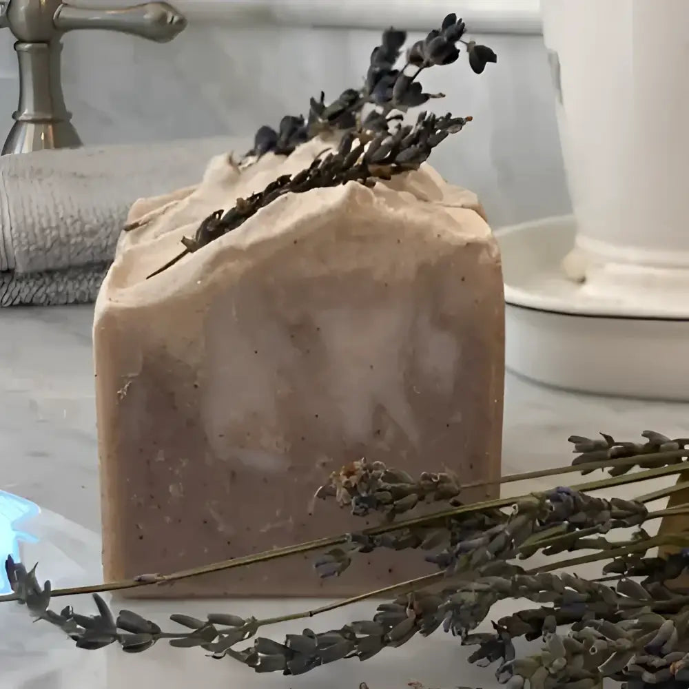  French Lavender shea butter bar soap, features a soothing lavender aroma complemented by bergamot, lemon, and eucalyptus top notes. The artisanal production process ensures each bar has distinctive color variations and unique swirl patterns.