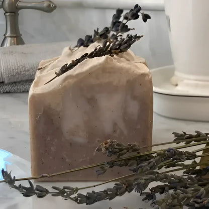  French Lavender shea butter bar soap, features a soothing lavender aroma complemented by bergamot, lemon, and eucalyptus top notes. The artisanal production process ensures each bar has distinctive color variations and unique swirl patterns.