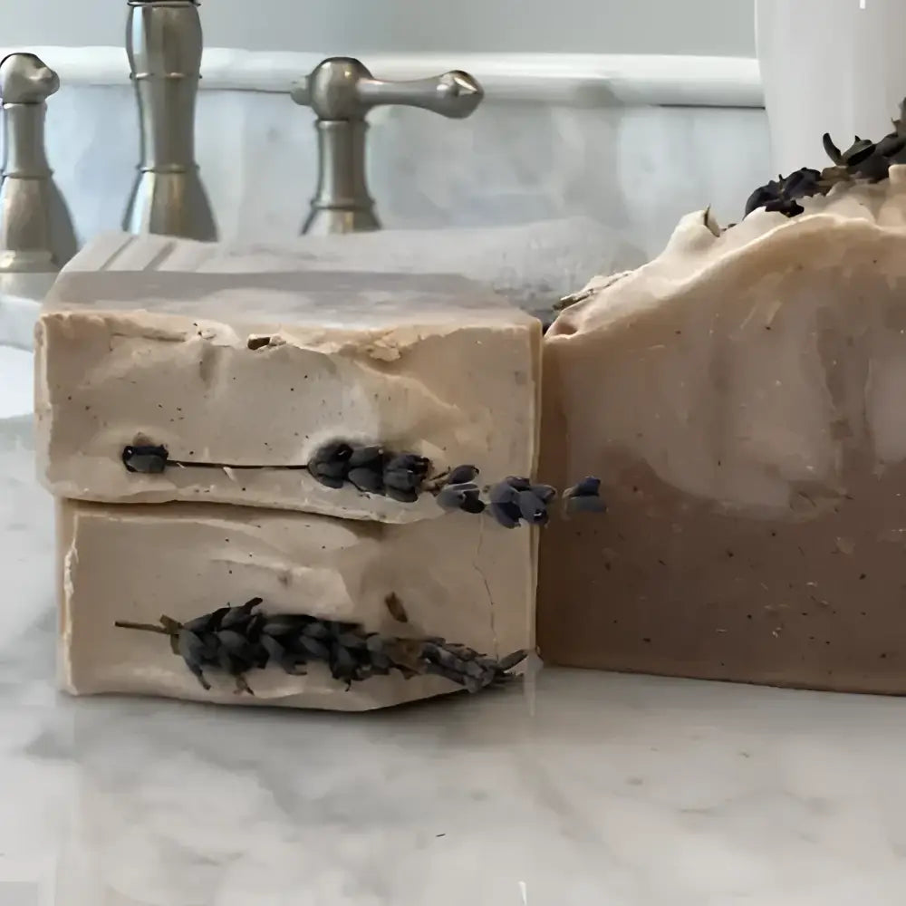  French Lavender shea butter bar soap, features a soothing lavender aroma complemented by bergamot, lemon, and eucalyptus top notes. The artisanal production process ensures each bar has distinctive color variations and unique swirl patterns.