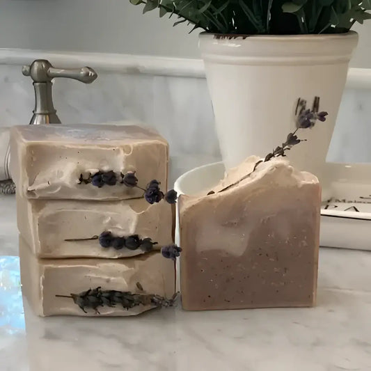  French Lavender shea butter bar soap, features a soothing lavender aroma complemented by bergamot, lemon, and eucalyptus top notes. The artisanal production process ensures each bar has distinctive color variations and unique swirl patterns.
