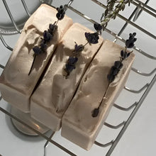  French Lavender shea butter bar soap, features a soothing lavender aroma complemented by bergamot, lemon, and eucalyptus top notes. The artisanal production process ensures each bar has distinctive color variations and unique swirl patterns.