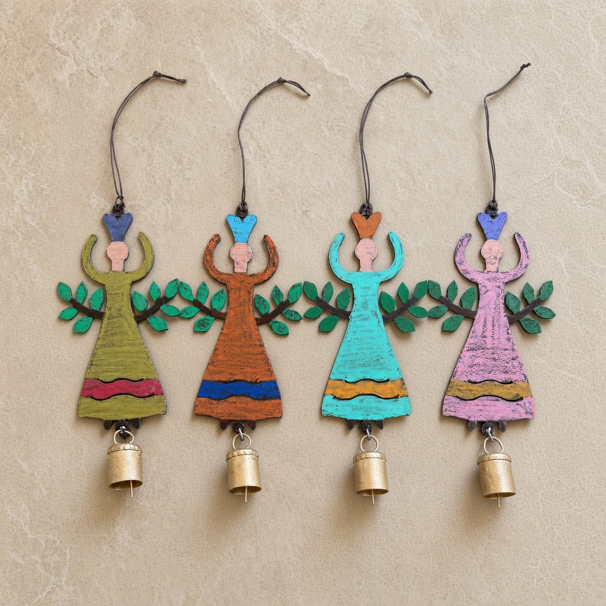 Four hand-painted wooden garden angel bell ornaments with outstretched arms and leafy branches for hanging