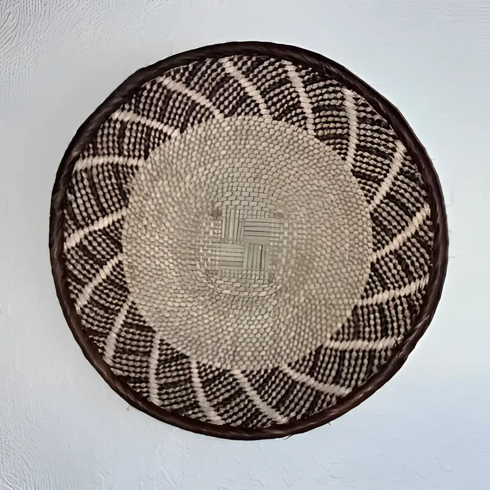 Round woven basket with a pattern on a white background