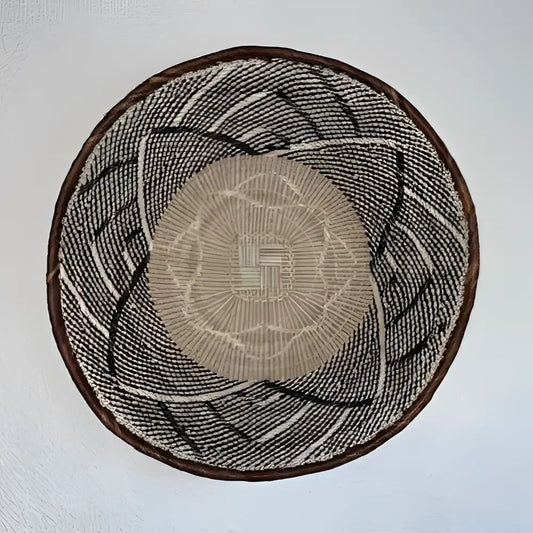 Round woven mat with concentric circle pattern on a plain background