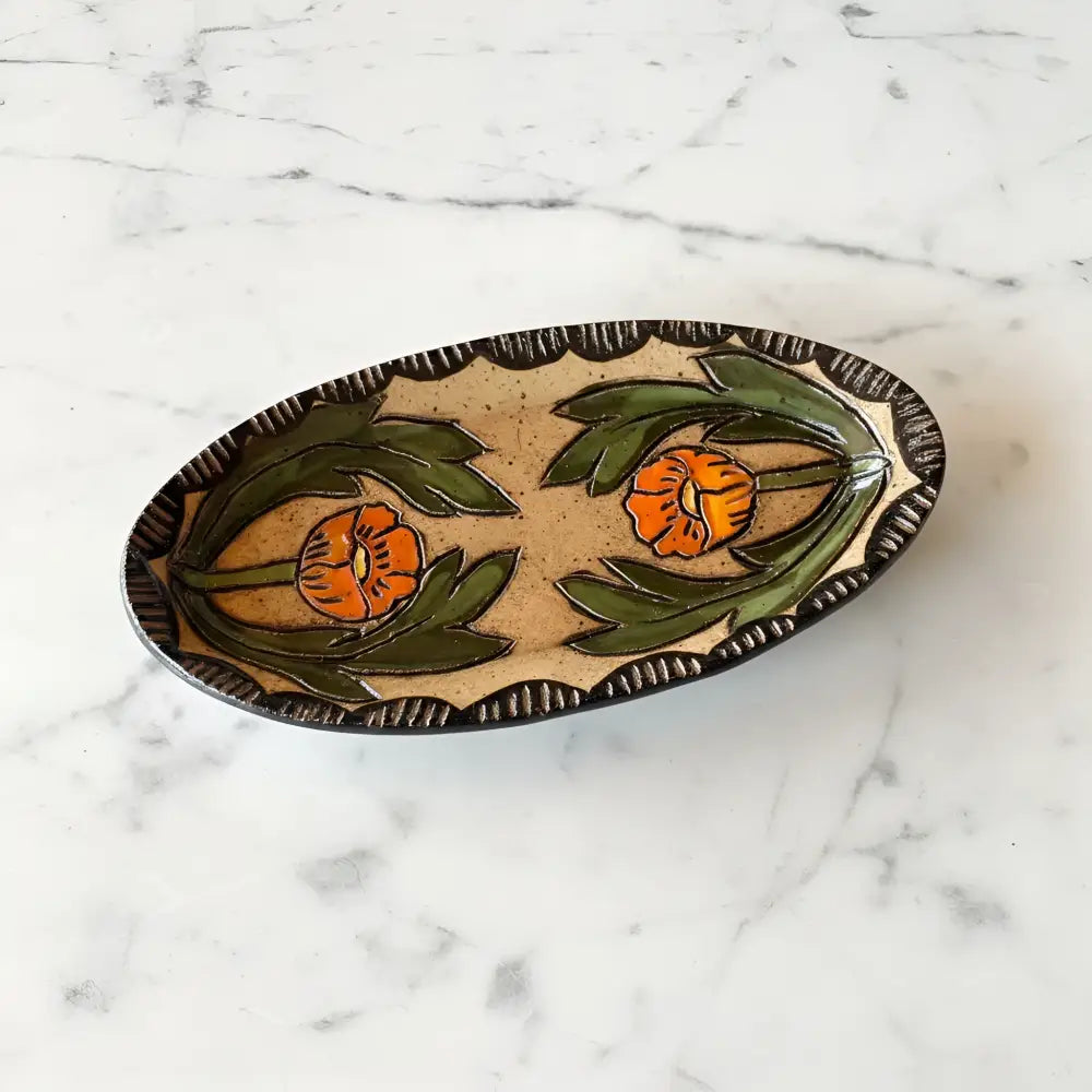 Oval handcrafted ceramic trinket dish with beige base globe mallow design and dark brown textured border