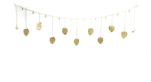 Handmade golden monstera leaf garland with chains, bells, clear coat, eco-friendly