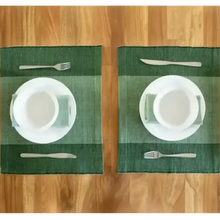 Green Ethiopian cotton table runner with white dinnerware and silverware on green placemats