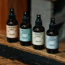Four amber glass Greyhaven Room Spray bottles with sea air pinewood scent blending salt air