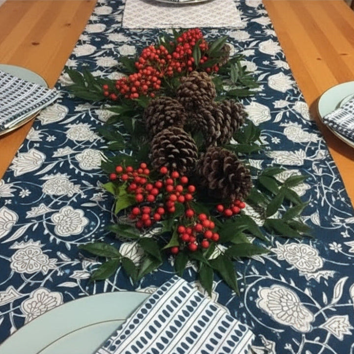 Hand block printed fair trade pinecone and berry table runner on blue patterned fabric