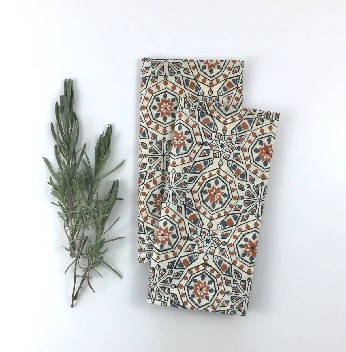 Two folded hand block printed fair trade organic cotton cloths with geometric pattern