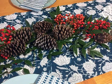 Hand block printed fair trade pinecone and berry table runner on blue patterned fabric