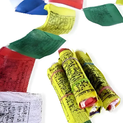 Bright yellow hand block printed tibetan prayer flag strand with black script rolled and tied with colorful elastics